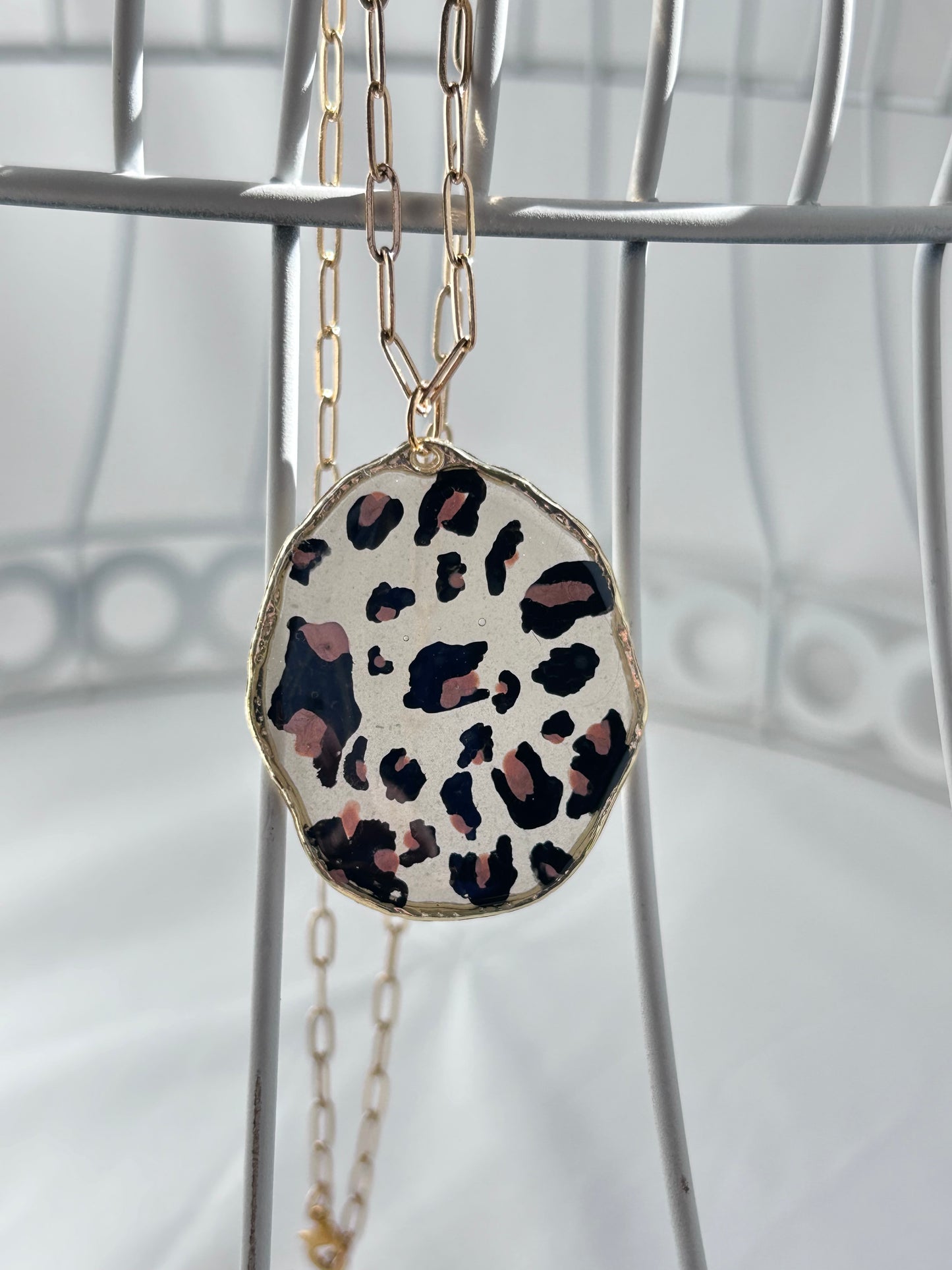 Handpainted Leopard Print Pendant Necklace, lightly tinted opaque resin, gold frame and 23” adjustable gold chain