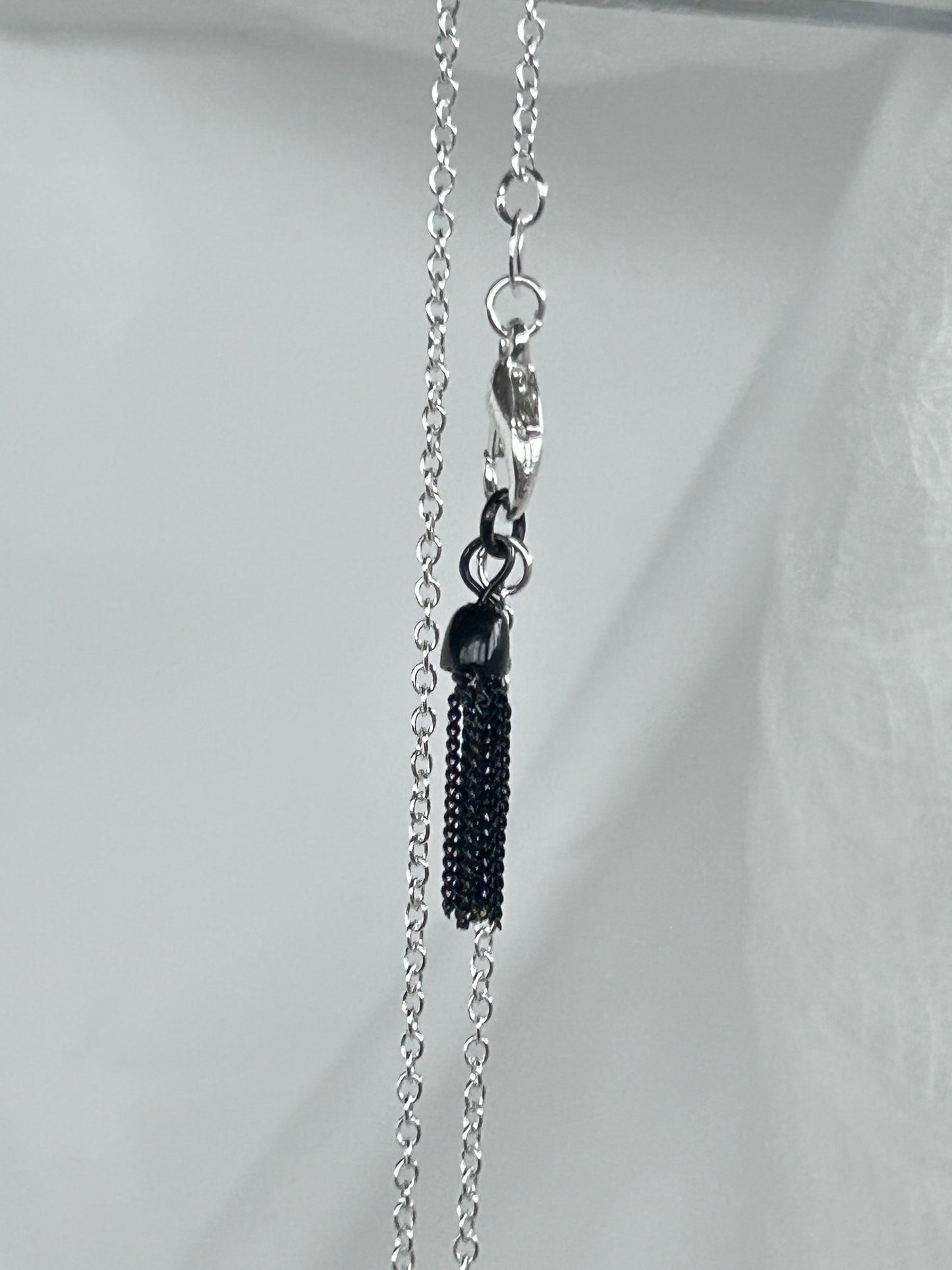 Smokey Black and Silver pendant adorned with dried leaves