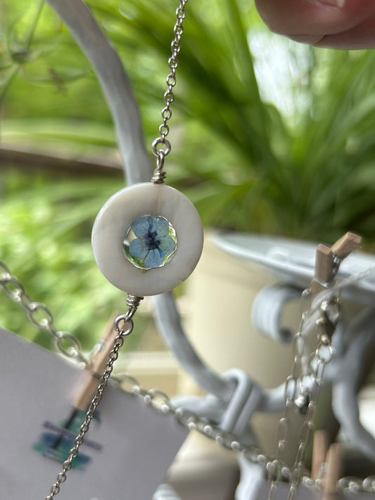 Mother’s Day Forget-Me-Not Pendant Necklace in a Mother of Pearl frame.