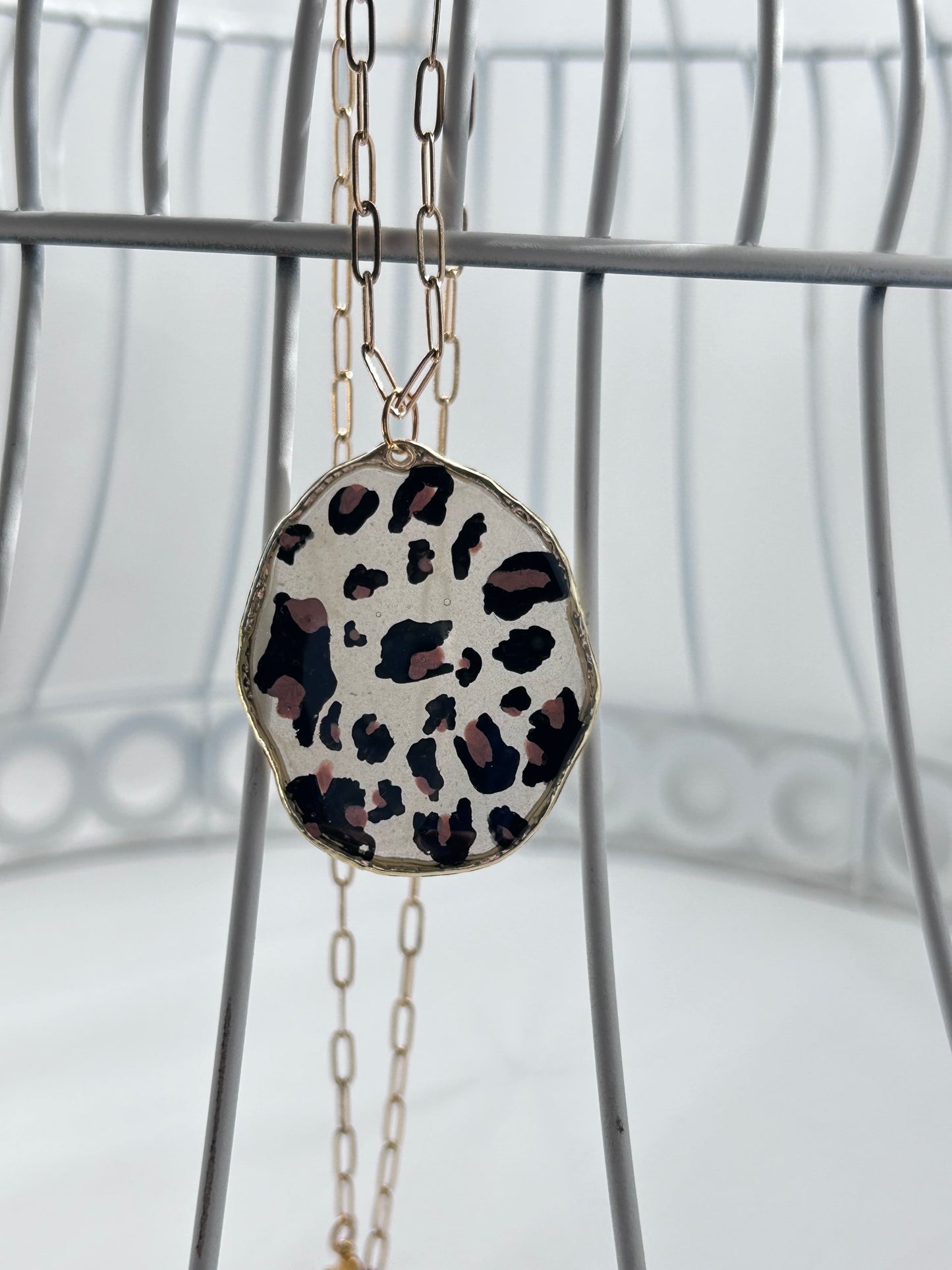 Handpainted Leopard Print Pendant Necklace, lightly tinted opaque resin, gold frame and 23” adjustable gold chain